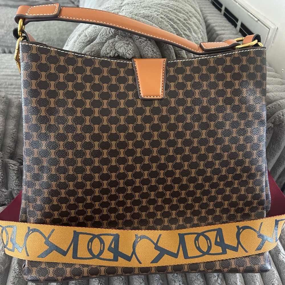 Brown Patterned Shoulder Bag with Tan Trim and Decorative Strap